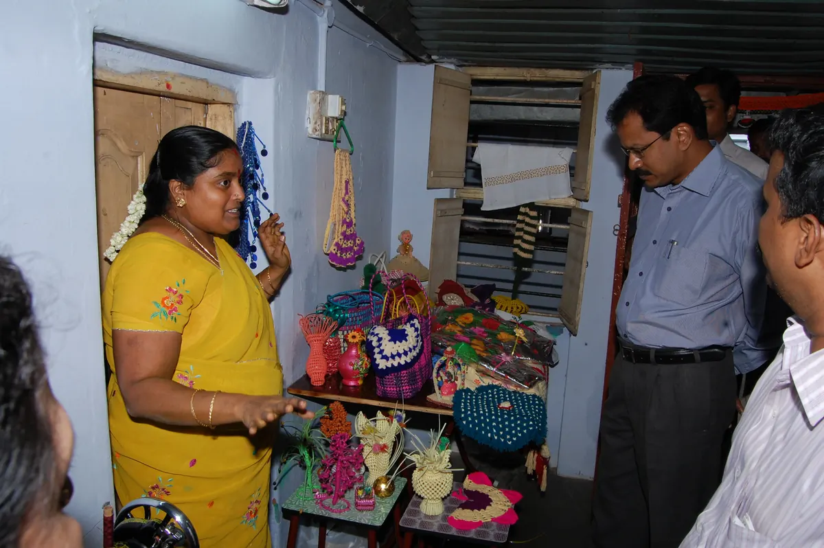 District Collector Mr. Palanichamy inspecting handmade craft items, bags, and embroidery at NWDT