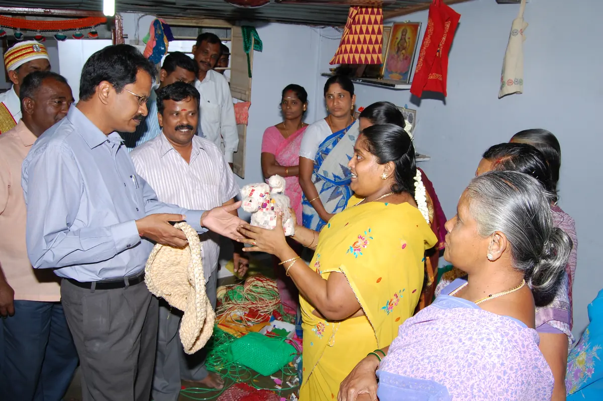 District Collector Mr. Palanichamy examining handmade fibre toys and soft goods made by women